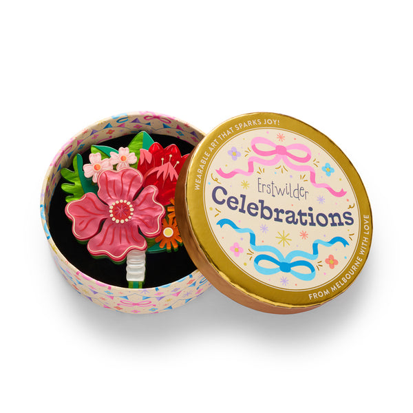 layered acrylic resin pink, orange, green, and red floral bouquet brooch, shown in illustrated round gift box packaging.