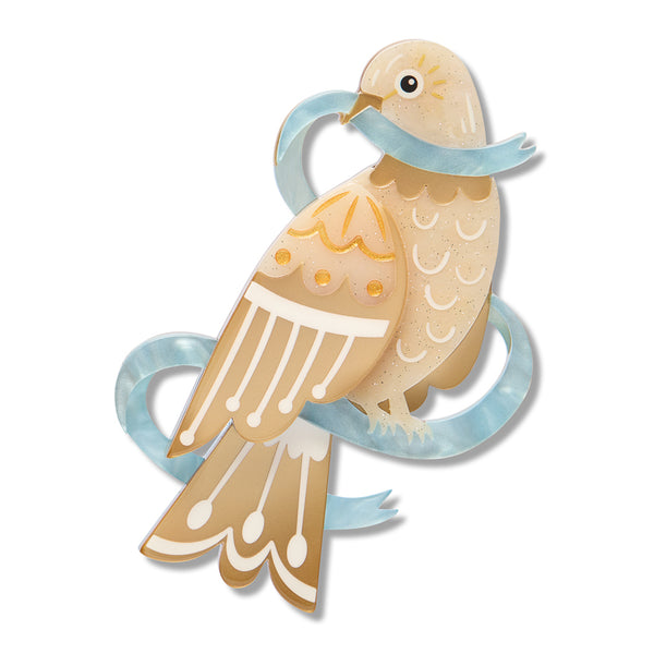 dove acrylic resin brooch in warm beige and tan tones with white patterned details, a light blue ribbon around its neck, and a small black eye, shown on a plain white background.