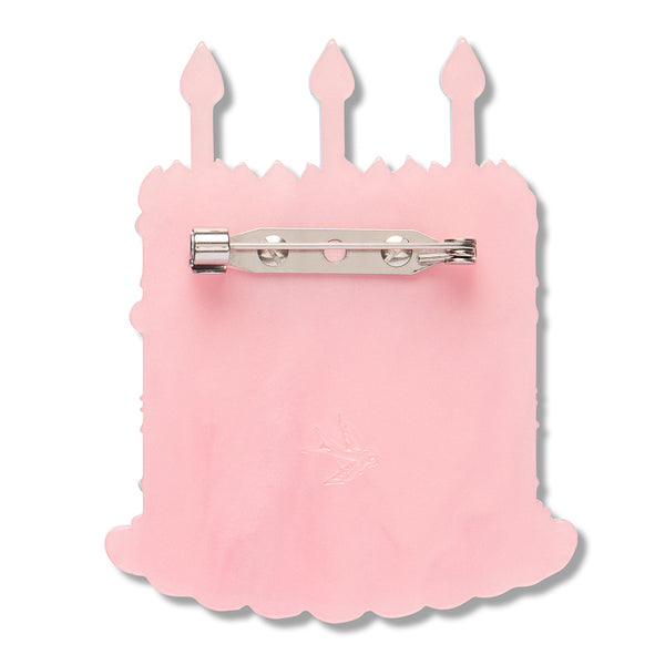pale pink acrylic resin back layer of birthday cake shaped brooch with silver metal pin clasp