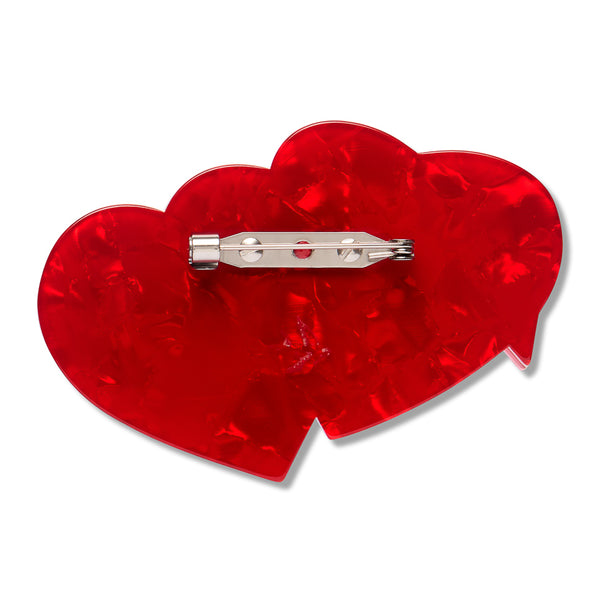 red acrylic resin back layer of two overlapping hearts shaped brooch with silver metal pin clasp