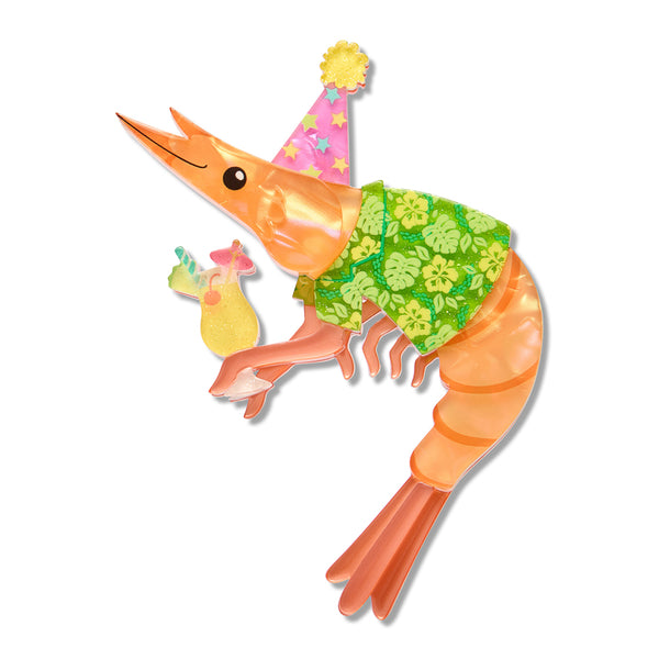A cartoon shrimp acrylic resin brooch with an orange body, wearing a pink party hat with yellow stars and a green floral shirt, holding a tropical drink on a plain white background.