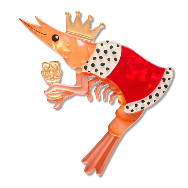 A stylized shrimp layered acrylic resin brooch with a gold crown, red body, white-and-black spotted trim, and a small gold cup, shown on a plain white background.