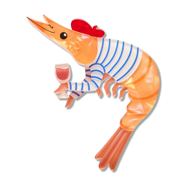 A stylized cartoon prawn layered acrylic resin brooch on a plain white background. The prawn is orange with a blue-and-white striped body, a red beret, and holds a pink drink in one claw.