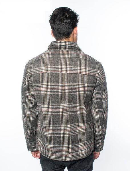 Guy's sizing brown, black, and cream plaid thick flannel jacket with black snaps closure, featuring chest and hand pockets. Shown back view on model.