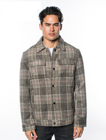 Guy's sizing brown, black, and cream plaid thick flannel jacket with black snaps closure, featuring chest and hand pockets. Shown worn by model.
