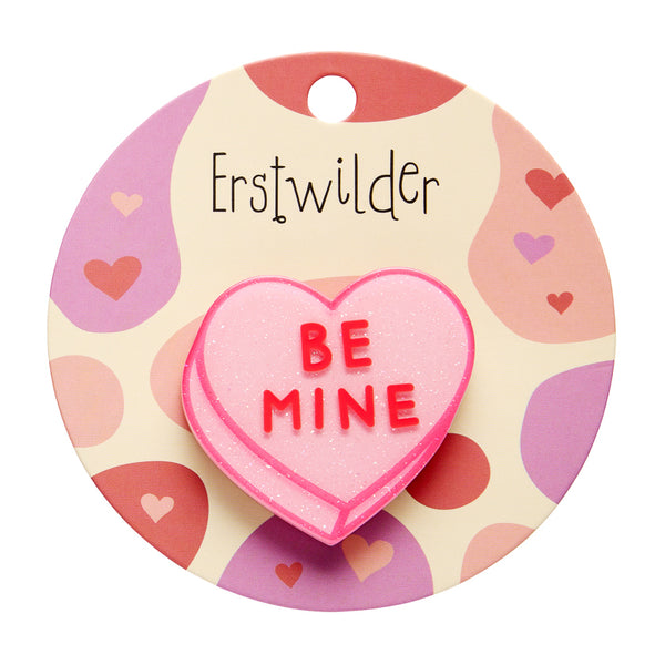 Heart-shaped 'BE MINE' candy brooch on a branded card with 'Erstwilder' logo