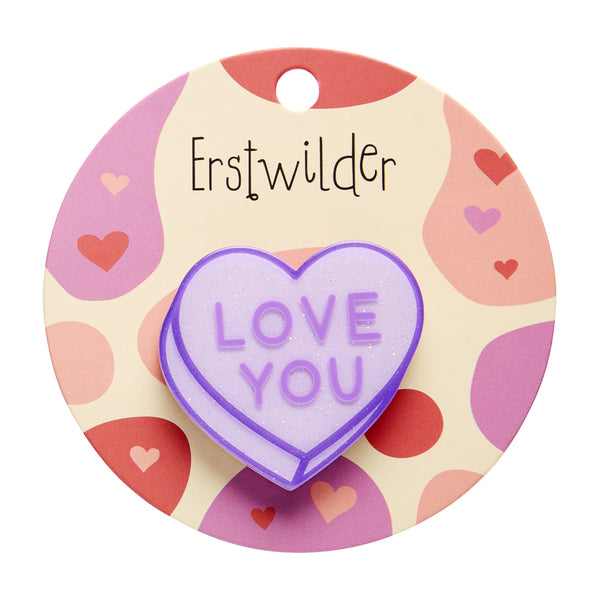 "LOVE YOU" text light purple glitter resin candy heart brooch, shown on branded backer card packaging