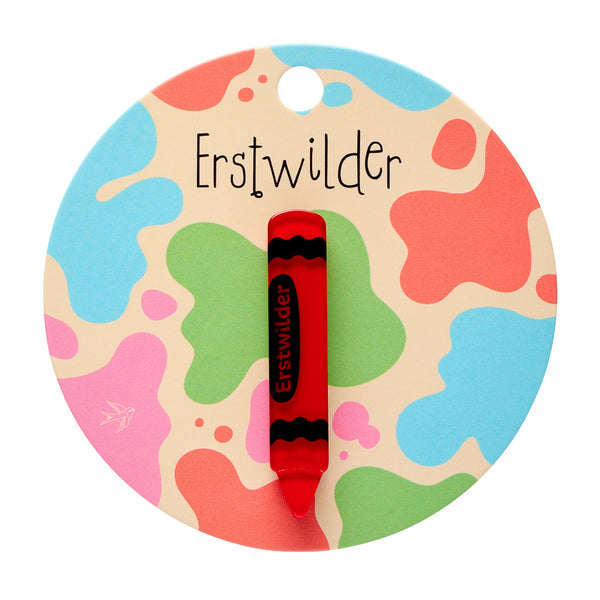 red with black details acrylic resin "Erstwilder" brand crayon-shaped mini brooch, shown on colorful backer card packaging