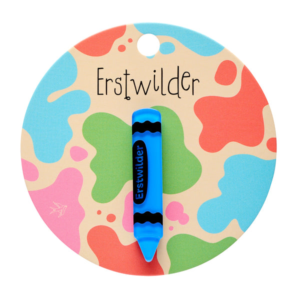 blue with black details acrylic resin "Erstwilder" brand crayon-shaped mini brooch, shown on colorful backer card packaging