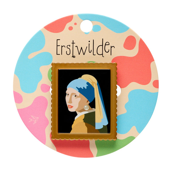 acrylic resin brooch depicting Johannes Vermeer's 1665 painting "Girl with a Pearl Earring" in a metallic gold frame, shown on colorful backer card packaging
