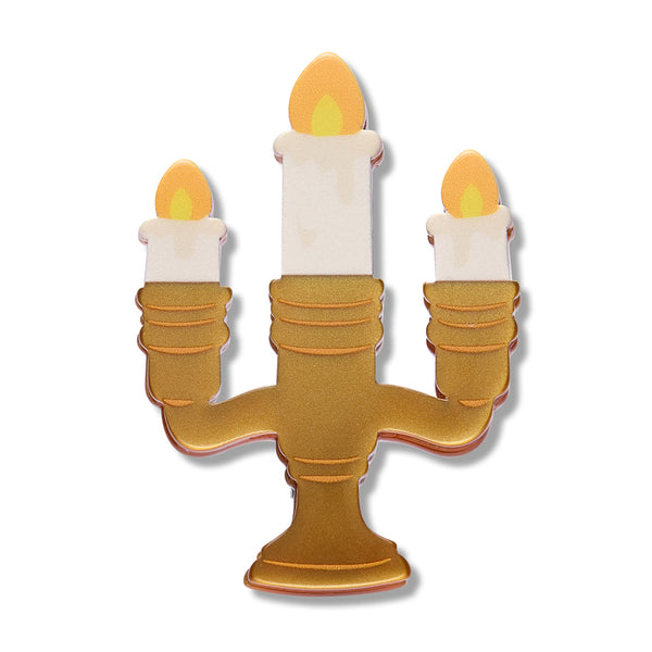 white, yellow, and metallic gold resin candelabra with lit candles brooch