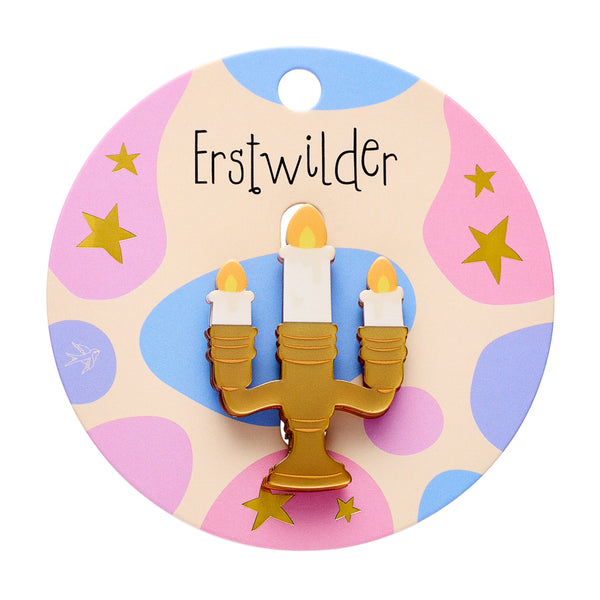 white, yellow, and metallic gold resin candelabra with lit candles brooch, shown on branded backer card