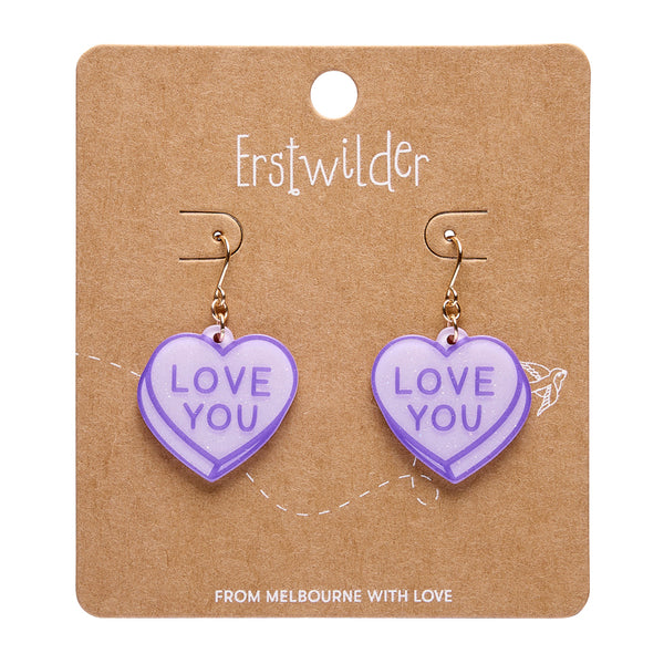 pair "LOVE YOU" text candy heart dangle earrings in light purple glitter resin, shown on branded backer card packaging