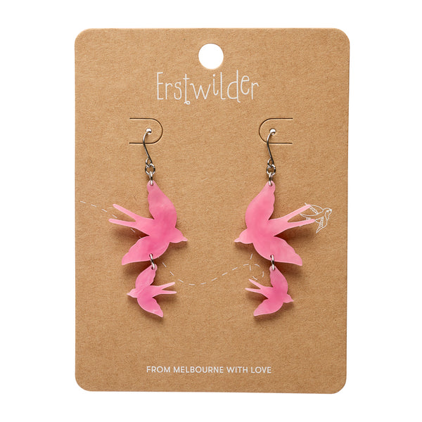 Pink bird-shaped earrings on a brown card with 'Erstwilder' branding.