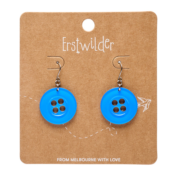 Blue button earrings on a brown card with 'Erstwilder' branding.