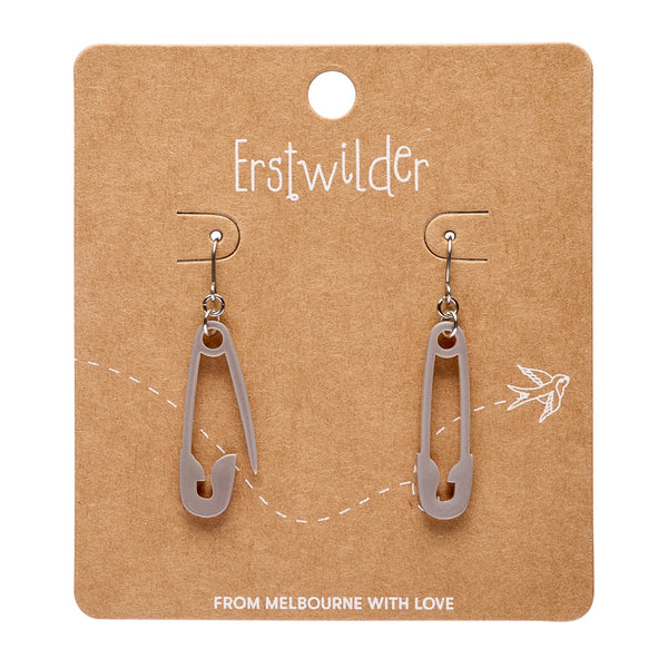 Pair of silver acrylic resin safety pin earrings on a brown card with 'Erstwilder' branding.