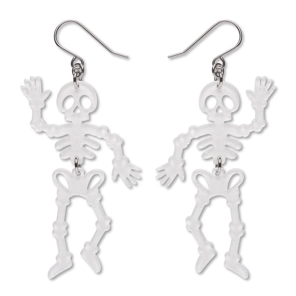 A pair of dangling glitter white acrylic resin skeleton earrings with silver-toned fishhook wires, shown on a plain white background.