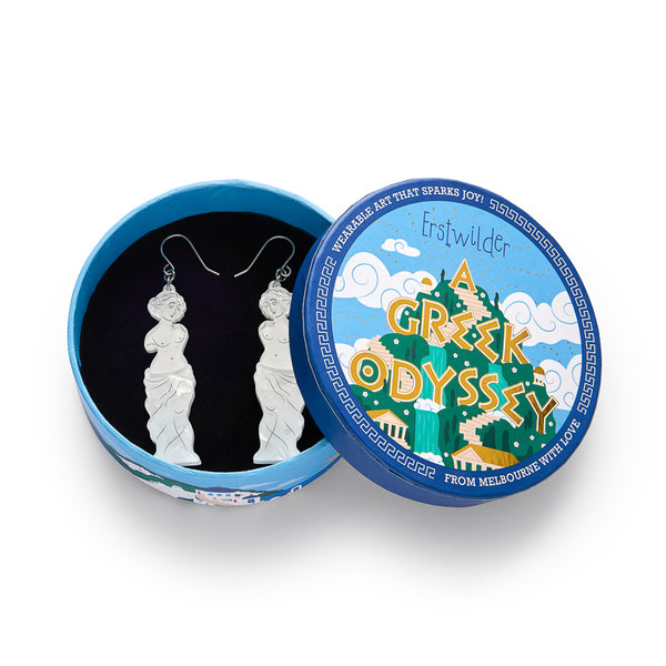 pair of white layered acrylic resin statue of Aphrodite dangle earrings, shown in illustrated round box packaging