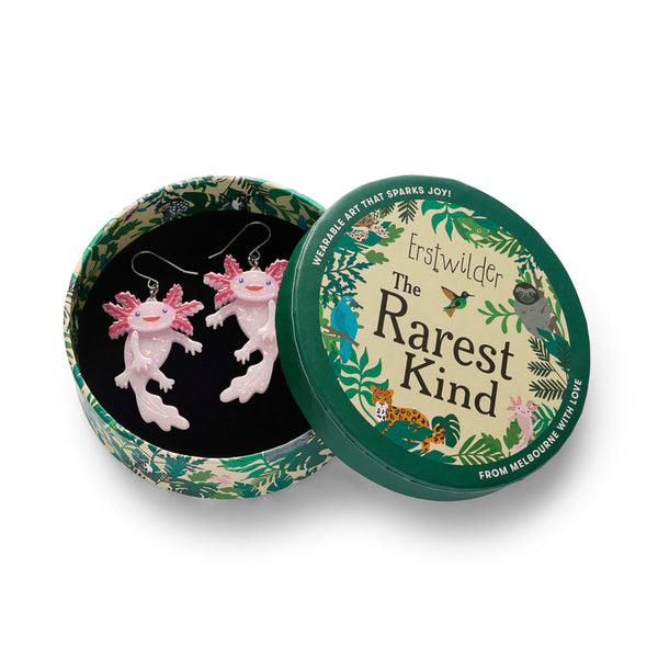pair of pink axolotl shaped dangle earrings, shown in illustrated round box packaging