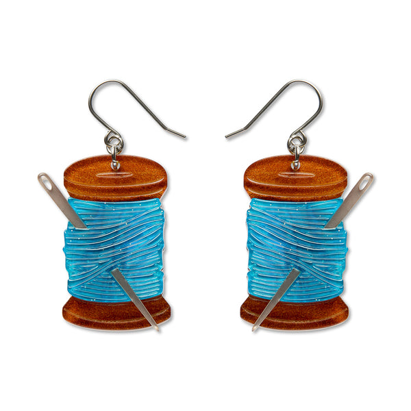 pair of spools of blue thread with metallic silver needle acrylic resin dangle earrings