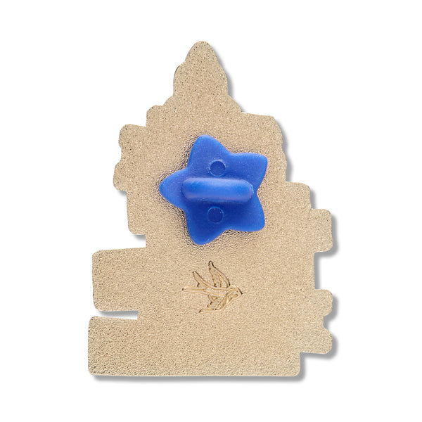 back view of gold metal stack of books shaped clutch back pin with blue rubber star-shaped fastener 