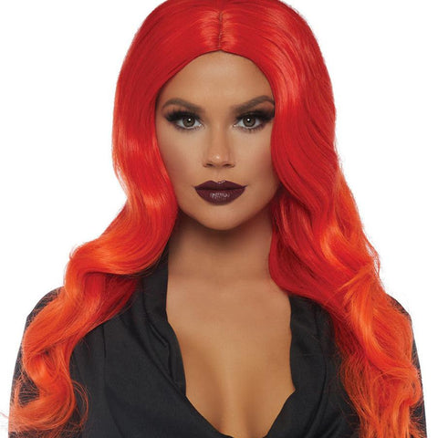 Model wearing center part wavy 27” long red wig with fiery orange ombré ends. Shown from front