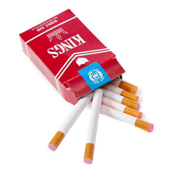 Open pack of “Kings” bubblegum “cigarettes” with “cigarettes” spilling out with pink gum visible on a white background