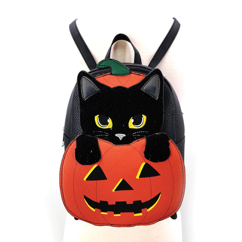 Faux leather mini backpack in the shape of a jack-o’-lantern with a black cat inside popping out. The cat detail is made of a black velvety fabric. Shown from front