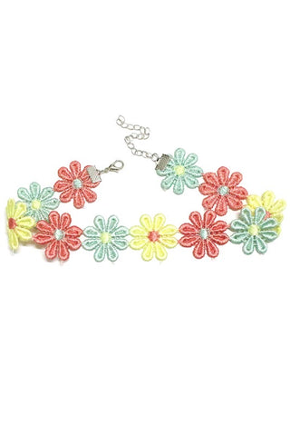 Choker necklace made of minty green, coral, and buttery yellow fabric daisy appliqués with silver metal lobster claw hardware. Seen flat