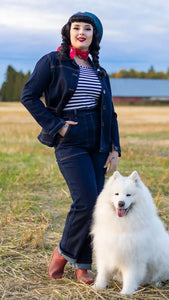 A model wearing indigo colored reproduction 1950s high waisted jeans.