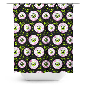 fabric shower curtain with an all-over neon pink and green bloodshot eyeball print on a black background
