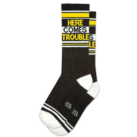 "Here Comes Trouble” text yellow, black, and white ribbed knit stretch cotton blend crew length gym socks, shown flat