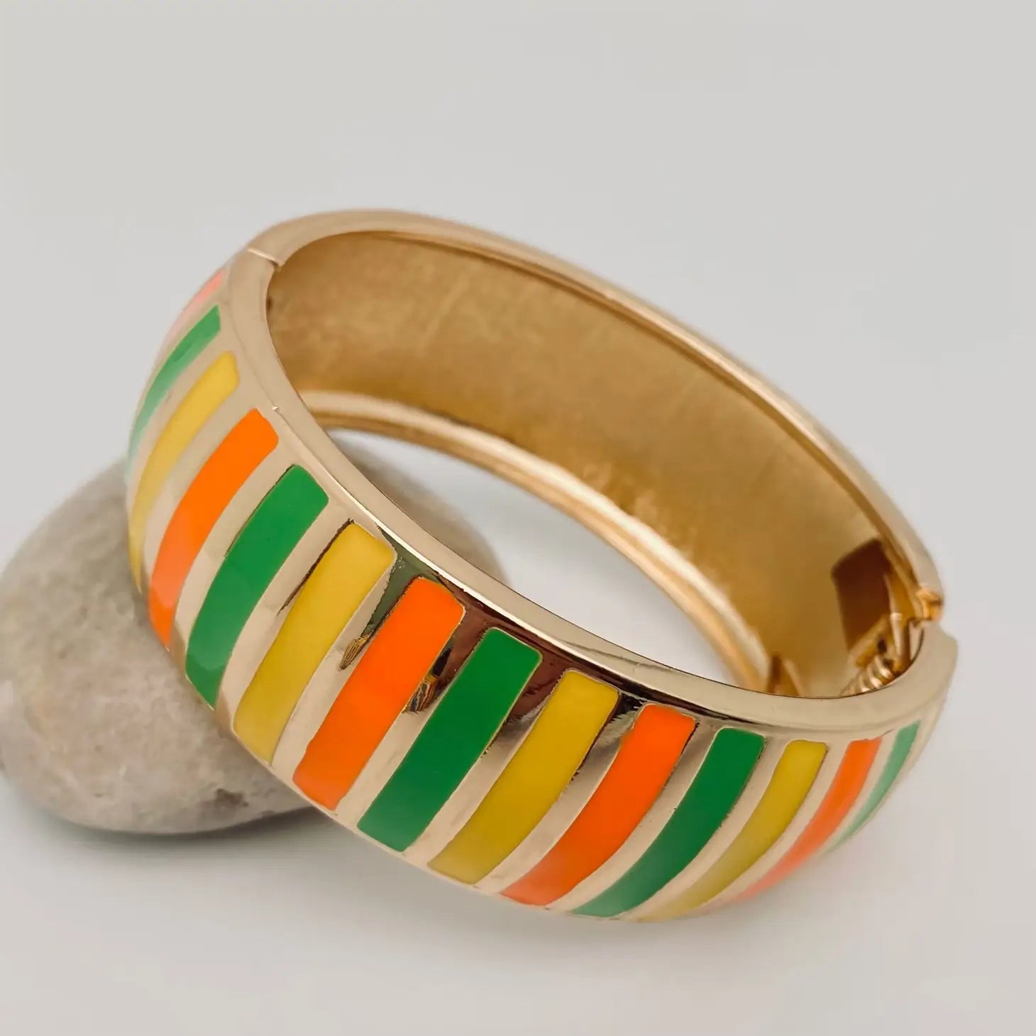 gold metal bangle with enameled yellow, green, and orange stripes & spring hinge and opening