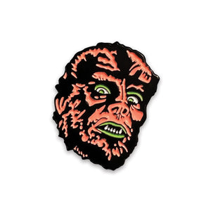 Black & neon orange and yellow enameled pin with matte finish in the shape of a werewolf’s head