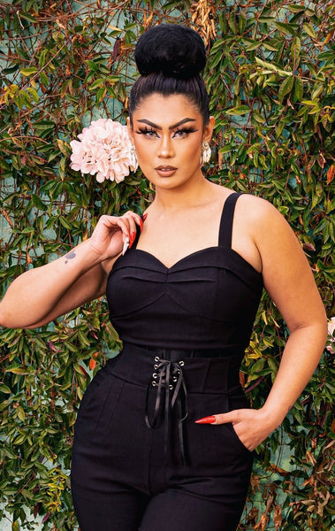 A model wearing a black Bengaline bustier style crop top with a sweetheart neckline and pleating at the bust. Shown from the front