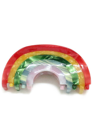 claw-style hair clip in the shape of a rainbow made of semi-opaque marbled acetate, in stripes of red/yellow/green/blue/pink