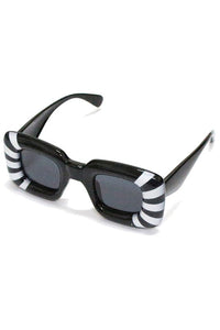 Oversized black sunglasses with extra thick square frames and white stripe detail at each temple