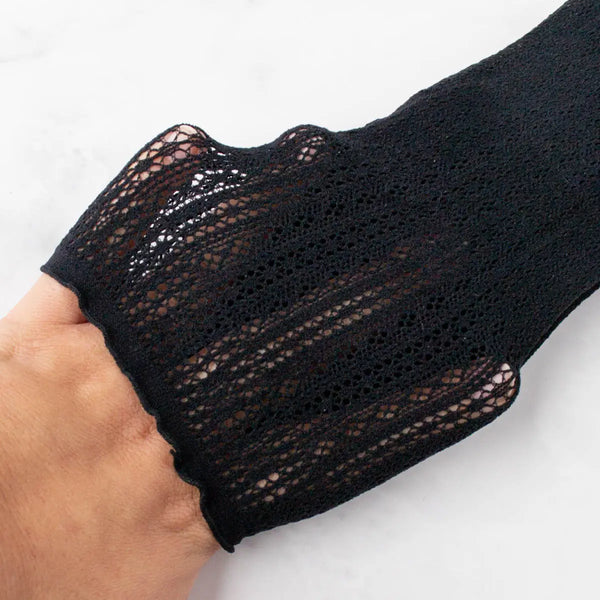 cotton knit socks with rolled top band in a classic black geometric openwork design. Shown held taut to display openwork design 