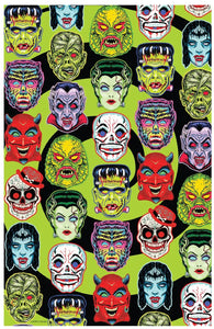 Throw blanket with all-over vibrantly colored print of retro Halloween monster masks on a swirled black and bright green background 