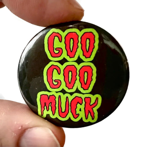 Title of the song “GOO GOO MUCK” by The Cramps in a wavy bright red and green font on a 1 1/2” round plastic pinback button
