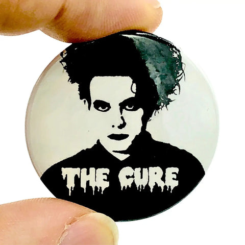 stylized black and white portrait of Robert Smith of The Cure on a 1 1/2” round plastic pinback button