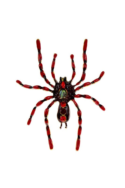 black and red striped enameled metal spider-shaped brooch inlaid with three large red jewels and a blue-green stone in the middle of its abdomen