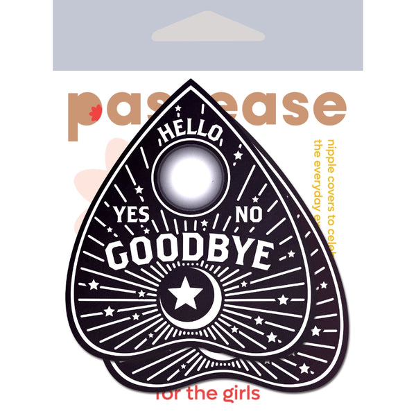 A pair of black and white Ouija board planchette shaped pasties shown in their packaging