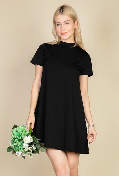 Model wearing a black short sleeved a-line t-shirt mini dress with a high collar. Shown from the front