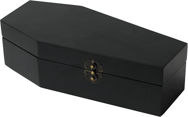 A black coffin shaped hinged trinket box lined with red velvety fabric on both interior sides. Shown closed