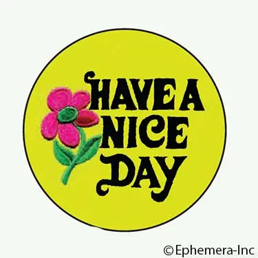 Vintage inspired “Have a Nice Day” 1.25" round metal pin-back button, black script on a yellow background with a pink and green flower illustration 