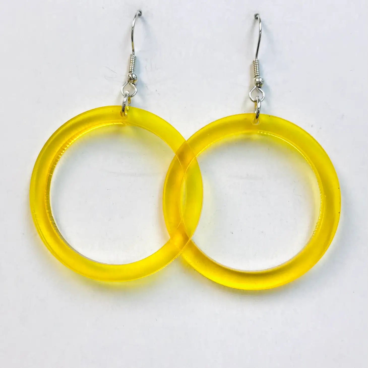 translucent acrylic drop hoop style earrings in a bright yellow color