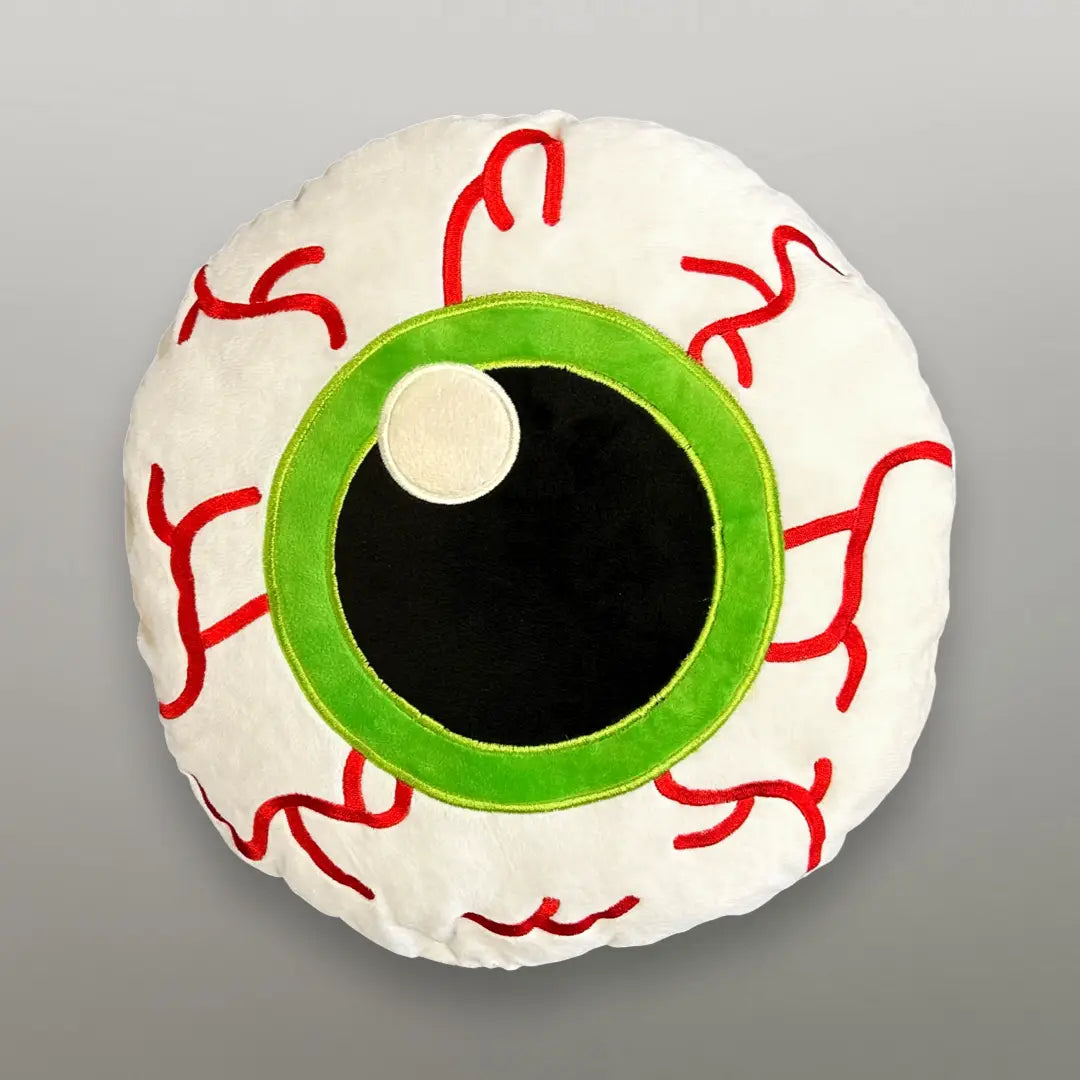Plush pillow in the shape of a round bloodshot eyeball with bright green iris