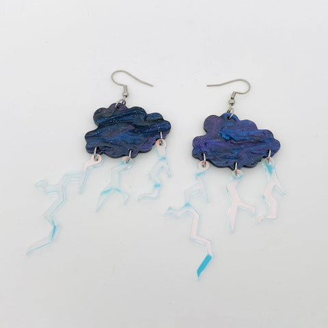 Swirly blue and purple acrylic storm cloud with linked iridescent flash finish lightning bolt charm dangle earrings. 
