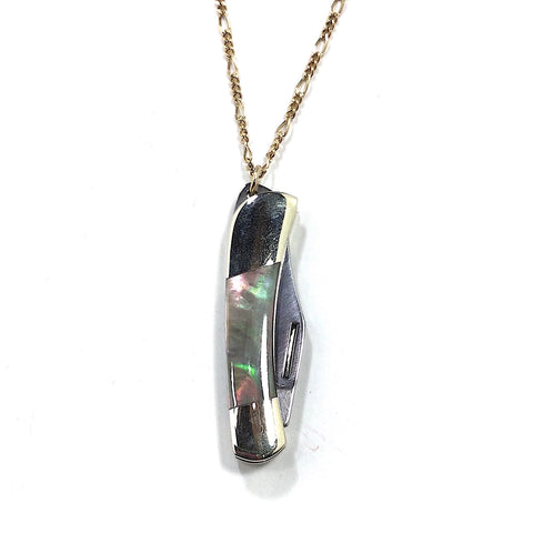 28” long brass Figaro style chain necklace with a mini stainless steel pocket knife pendant. Pendant has an abalone style finish on the handle. Shown up close with knife closed 